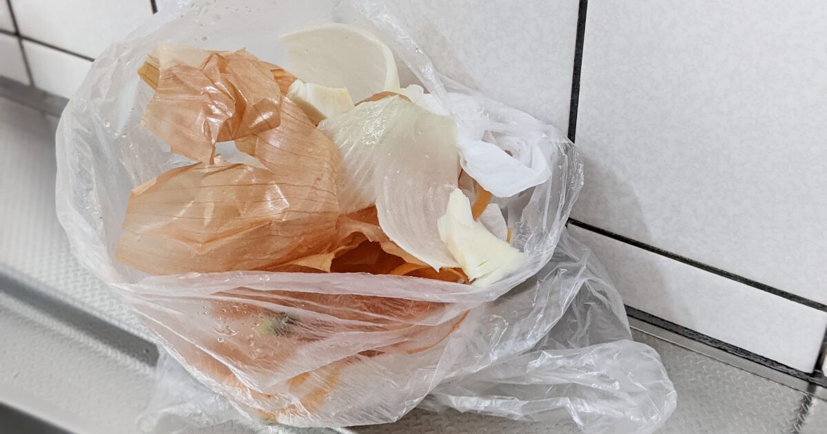ビニール袋に集められた玉ねぎの皮の食品廃棄物